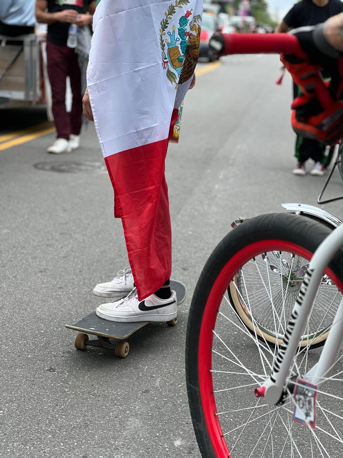 A rider carrying a Mexican flag during the Cinco de Mayo community ride