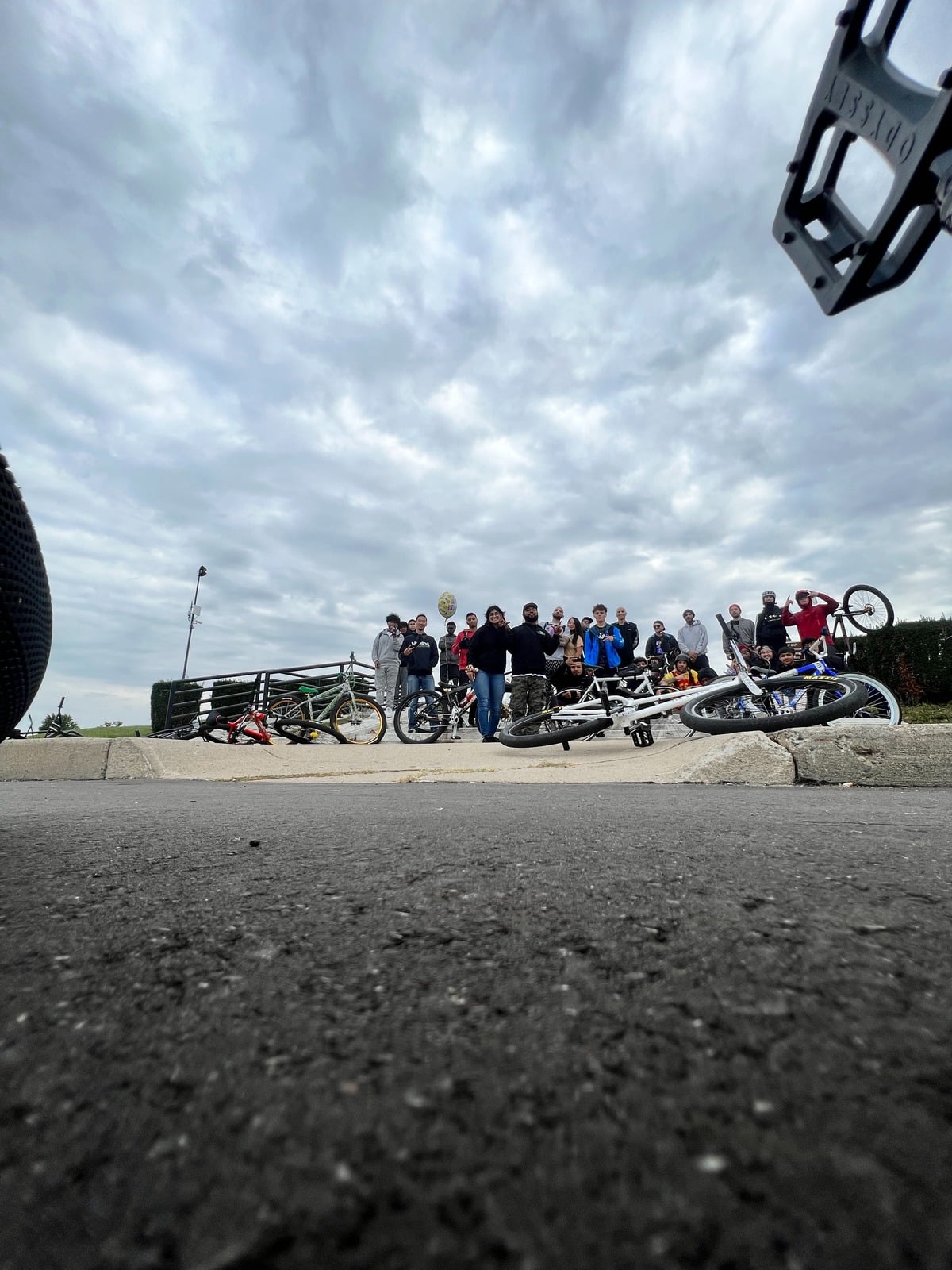A large group of BMX riders gathered together after a community ride