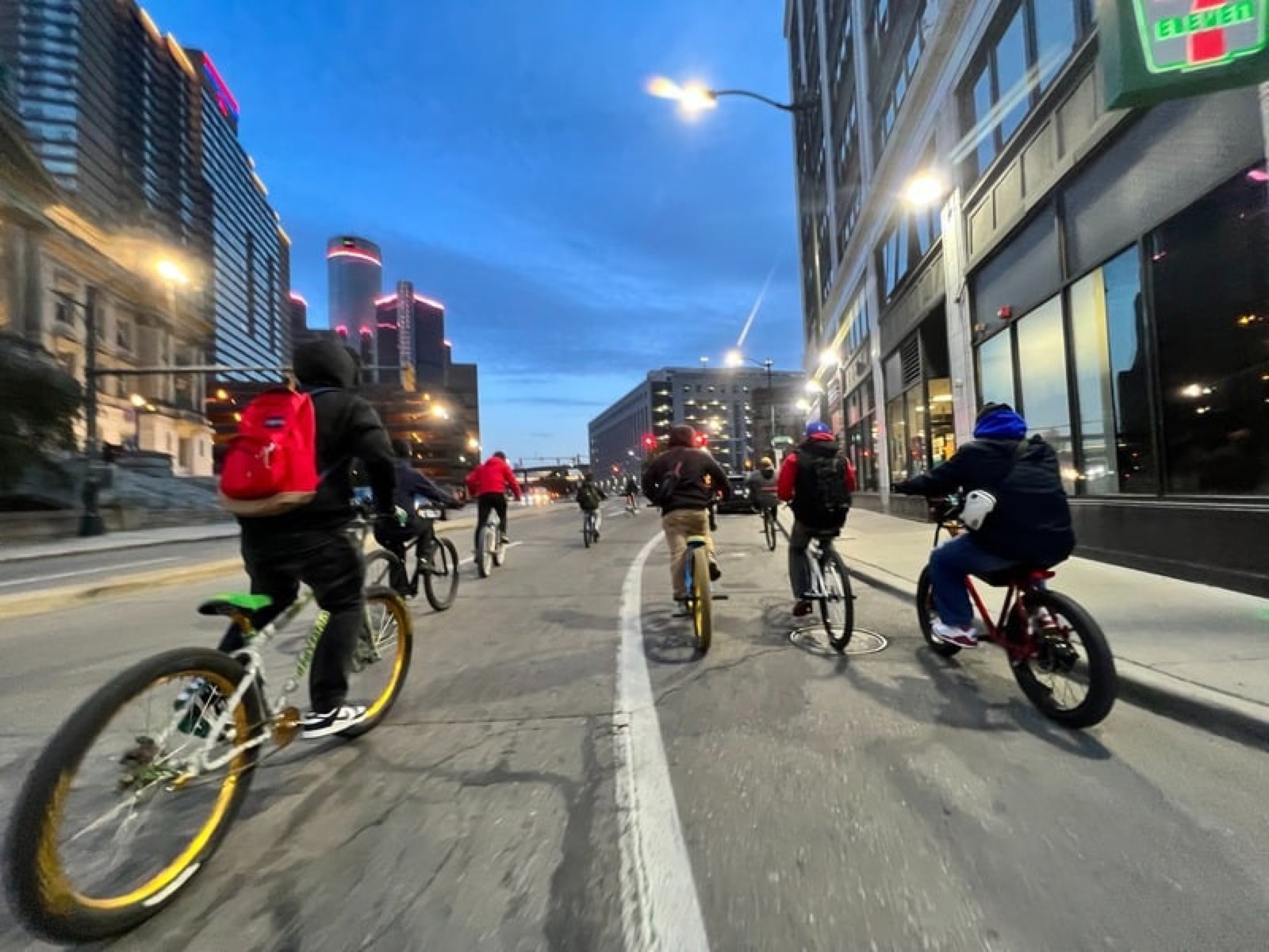 A group bike ride out through downtown Detroit at dusk