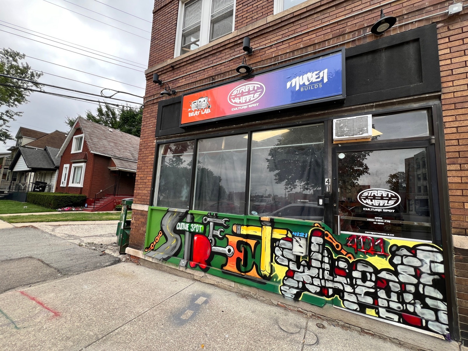 The Street Wheels Culture Spot storefront, painted with a bike-chain graffiti mural